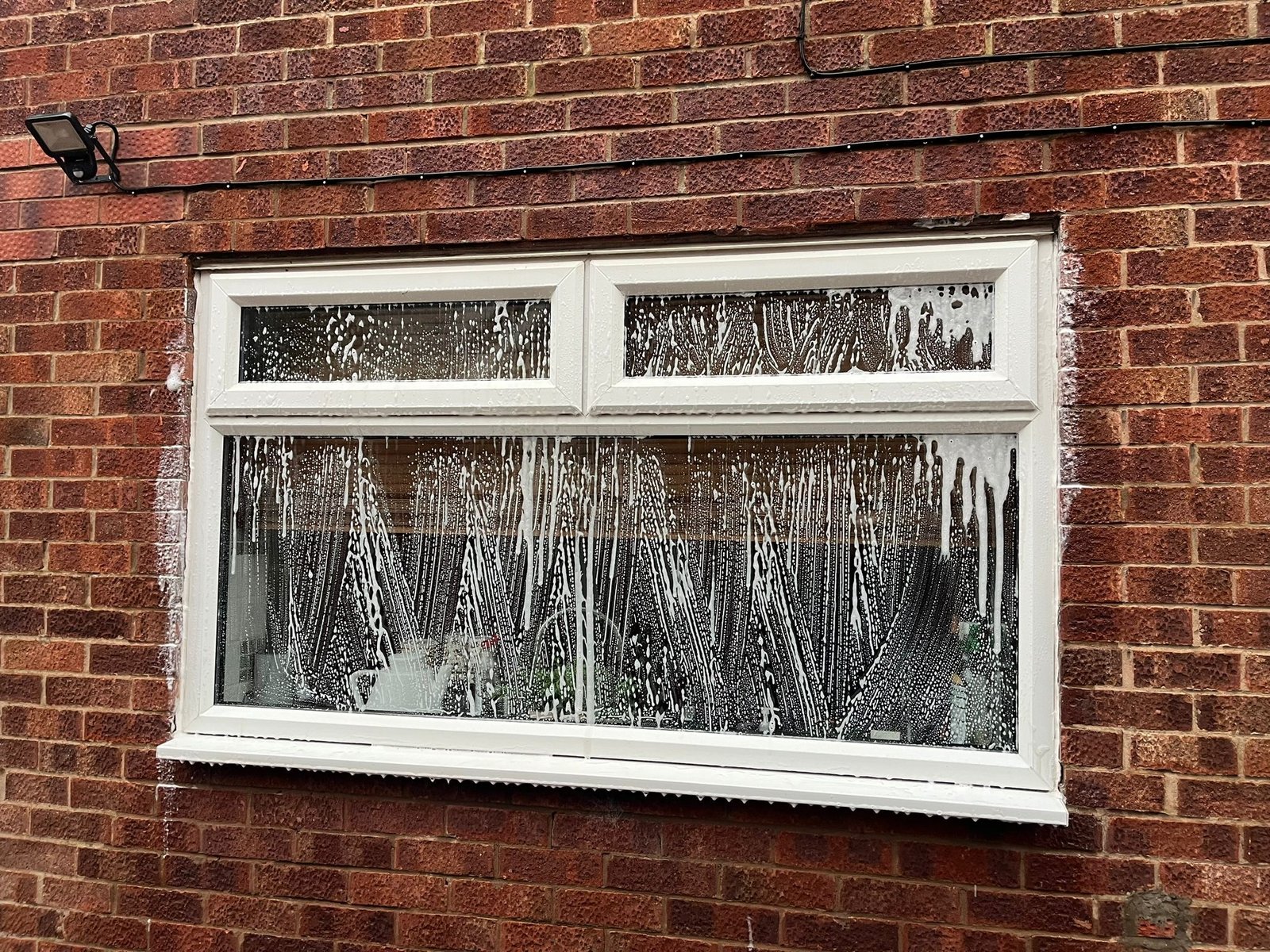 Before and after comparison of UPVC soffit cleaning showing dramatic results